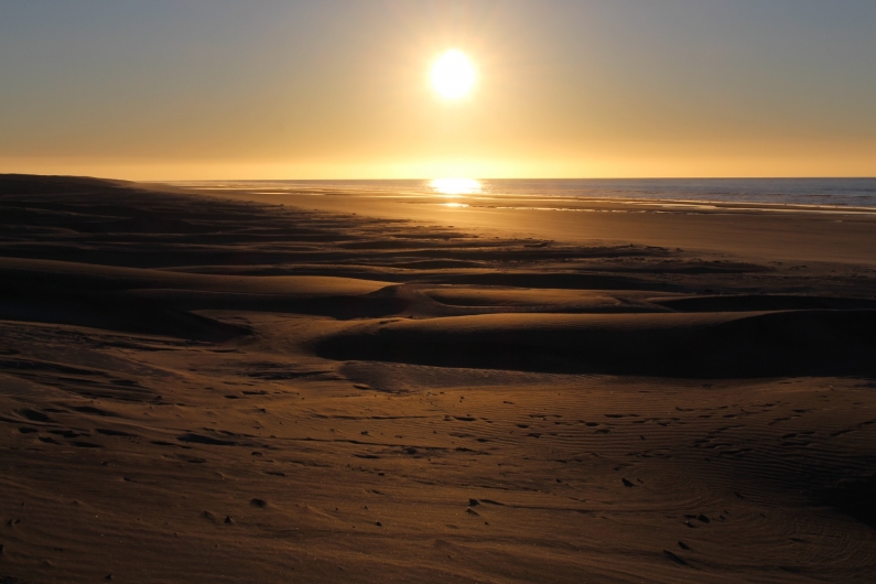 The sun setting on the dunes
